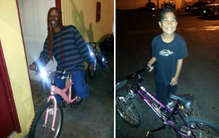 Two kids receive bikes from Motel Church volunteers on Christmas Eve