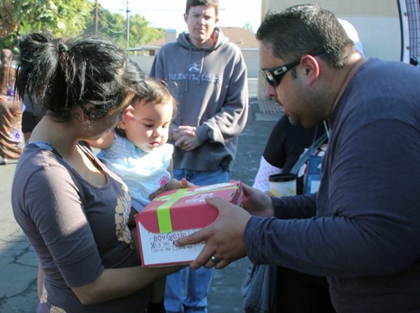 Volunteers giving away Christmas Boxes at Motel Church